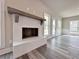 Living room fireplace with brick surround, wood mantle and large windows at 3154 Rosebud Rd, Loganville, GA 30052