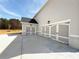 Three car garage with decorative doors and exterior lighting in a neutral color at 3154 Rosebud Rd, Loganville, GA 30052