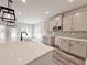 Bright kitchen with island, stainless steel microwave and modern lighting at 3154 Rosebud Rd, Loganville, GA 30052