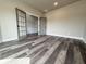 Bright and airy living room featuring hardwood flooring and paneled doors at 3154 Rosebud Rd, Loganville, GA 30052