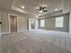 Spacious carpeted main bedroom with a tray ceiling and recessed lighting at 3154 Rosebud Rd, Loganville, GA 30052