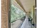 Covered balcony with furniture offering a serene view of a lush, green landscape at 5400 Roswell Rd # N1, Sandy Springs, GA 30342