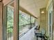 Outdoor balcony with seating and peaceful views of a wooded area beyond at 5400 Roswell Rd # N1, Sandy Springs, GA 30342