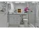 This bathroom features a shower with glass door, white tiling, and a marble topped vanity at 5400 Roswell Rd # N1, Sandy Springs, GA 30342