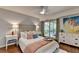 Inviting bedroom featuring a balcony, complemented by soft lighting and artistic decor at 5400 Roswell Rd # N1, Sandy Springs, GA 30342
