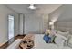 Cozy bedroom with hardwood floors, a ceiling fan, and access to a bright bathroom at 5400 Roswell Rd # N1, Sandy Springs, GA 30342