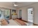 Bright bedroom featuring a ceiling fan, a sliding glass door, and a decorative painting at 5400 Roswell Rd # N1, Sandy Springs, GA 30342