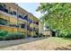 Apartment exterior with multiple balconies and spiral staircases amid lush landscaping at 5400 Roswell Rd # N1, Sandy Springs, GA 30342