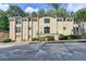 Three-story apartment building with brick facade, well-maintained landscaping, and ample parking at 5400 Roswell Rd # N1, Sandy Springs, GA 30342
