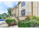 Brick building with well-maintained landscaping, a front door, and a short staircase with wrought iron railings at 5400 Roswell Rd # N1, Sandy Springs, GA 30342
