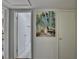 Hallway with a painting of trees and a view of a bathroom with marble floors at 5400 Roswell Rd # N1, Sandy Springs, GA 30342