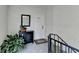 Hallway entrance with a mirror, decorative cabinet, houseplant, and gray carpet at 5400 Roswell Rd # N1, Sandy Springs, GA 30342