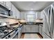 Bright kitchen with stainless steel appliances, gas range, white cabinets and subway tile backsplash at 5400 Roswell Rd # N1, Sandy Springs, GA 30342