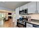 Modern kitchen with white cabinets, stainless steel microwave, and an open layout at 5400 Roswell Rd # N1, Sandy Springs, GA 30342