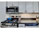 Modern kitchen featuring stainless steel appliances, black countertops, subway tile backsplash and white cabinets at 5400 Roswell Rd # N1, Sandy Springs, GA 30342