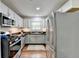 Bright kitchen with stainless steel appliances, gas range, white cabinets and subway tile backsplash at 5400 Roswell Rd # N1, Sandy Springs, GA 30342