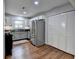 Galley kitchen featuring stainless steel appliances, white cabinets, and access to closet and dining area at 5400 Roswell Rd # N1, Sandy Springs, GA 30342