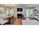 Open-concept living and dining area with hardwood floors, fireplace, and access to the outdoors at 5400 Roswell Rd # N1, Sandy Springs, GA 30342