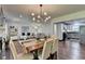 Open living and dining area featuring modern light fixtures, hardwood floors, and an open floor plan at 5400 Roswell Rd # N1, Sandy Springs, GA 30342