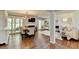 Bright living room with hardwood floors, a modern lighting fixture and a fireplace at 5400 Roswell Rd # N1, Sandy Springs, GA 30342