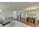 Living room and dining area with hardwood floors, modern lighting, and an open concept layout at 5400 Roswell Rd # N1, Sandy Springs, GA 30342