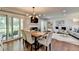 Spacious living and dining area featuring wood floors, modern lighting, a fireplace and balcony access at 5400 Roswell Rd # N1, Sandy Springs, GA 30342