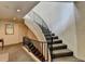 Carpeted staircase with a wrought iron railing and neutral walls, leading to the upper level at 5400 Roswell Rd # N1, Sandy Springs, GA 30342