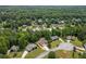 High-angle shot displaying the house in relation to the neighborhood and its lush, wooded setting at 102 Pine Bark Dr, Villa Rica, GA 30180