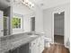 Bathroom featuring a vanity with granite counter and lots of mirror space at 102 Pine Bark Dr, Villa Rica, GA 30180