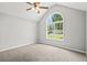 Vaulted ceiling bedroom with large window overlooking landscaped yard and plenty of natural light at 102 Pine Bark Dr, Villa Rica, GA 30180