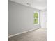 A cozy carpeted bedroom with natural light from a window at 102 Pine Bark Dr, Villa Rica, GA 30180