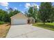 View of house featuring a two-car garage, manicured lawn, and inviting driveway at 102 Pine Bark Dr, Villa Rica, GA 30180