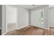 Bright foyer featuring wood-look floors, a white front door with sidelights, and access to adjacent rooms at 102 Pine Bark Dr, Villa Rica, GA 30180