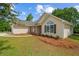 Attractive home exterior featuring stone accents, a manicured yard, and a welcoming front entrance at 102 Pine Bark Dr, Villa Rica, GA 30180