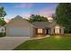 Inviting home featuring a two car garage, stone accents, a manicured lawn, and an inviting front entrance at 102 Pine Bark Dr, Villa Rica, GA 30180