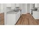 Kitchen featuring white cabinets, stainless steel appliances, granite counters and wood flooring at 102 Pine Bark Dr, Villa Rica, GA 30180
