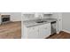 Well-lit kitchen features granite counters, stainless steel dishwasher, and views into the living area with stone fireplace at 102 Pine Bark Dr, Villa Rica, GA 30180