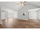 Spacious living room with wood-look floors, a vaulted ceiling, and a seamless flow into the kitchen at 102 Pine Bark Dr, Villa Rica, GA 30180