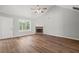 Inviting living room featuring wood-look floors, a fireplace, vaulted ceiling, and ample space at 102 Pine Bark Dr, Villa Rica, GA 30180