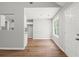 Bright, open layout with wood-look flooring, neutral walls, and views into the kitchen and front entrance at 102 Pine Bark Dr, Villa Rica, GA 30180