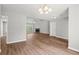 Open-concept living area featuring wood floors, fireplace, and white walls at 102 Pine Bark Dr, Villa Rica, GA 30180