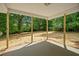 Covered patio that offers a relaxing outdoor space with views of the wooded backyard at 102 Pine Bark Dr, Villa Rica, GA 30180
