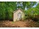 Storage shed in a private, wooded area, providing extra space for tools and equipment at 102 Pine Bark Dr, Villa Rica, GA 30180