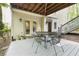 Relaxing back porch with an outdoor dining set and french doors that open to the home's interior at 230 Ridge Point Ct, Alpharetta, GA 30022