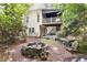 A beautiful backyard featuring a stone water feature, chairs, and a two-story home with plank siding at 230 Ridge Point Ct, Alpharetta, GA 30022
