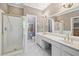 Bright bathroom featuring a glass-enclosed shower and a double vanity with gold fixtures at 230 Ridge Point Ct, Alpharetta, GA 30022