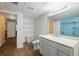 Bathroom features a vanity with a white countertop, handicap-accessible toilet, and open shelving unit at 230 Ridge Point Ct, Alpharetta, GA 30022