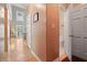 Hallway featuring hardwood floors, neutral walls, and an open doorway to a half bath at 230 Ridge Point Ct, Alpharetta, GA 30022
