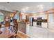 Bright kitchen boasts white cabinets, stainless steel appliances, and granite countertops at 230 Ridge Point Ct, Alpharetta, GA 30022