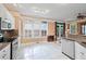 Spacious kitchen with white cabinetry, granite countertops, and backyard view at 230 Ridge Point Ct, Alpharetta, GA 30022